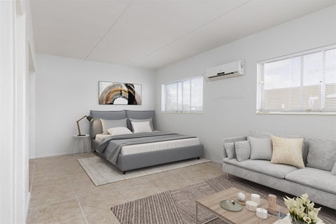 a bedroom with a bed and a couch