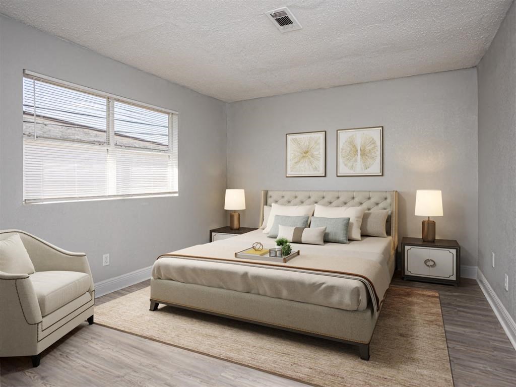 a bedroom with a bed and a chair and a window