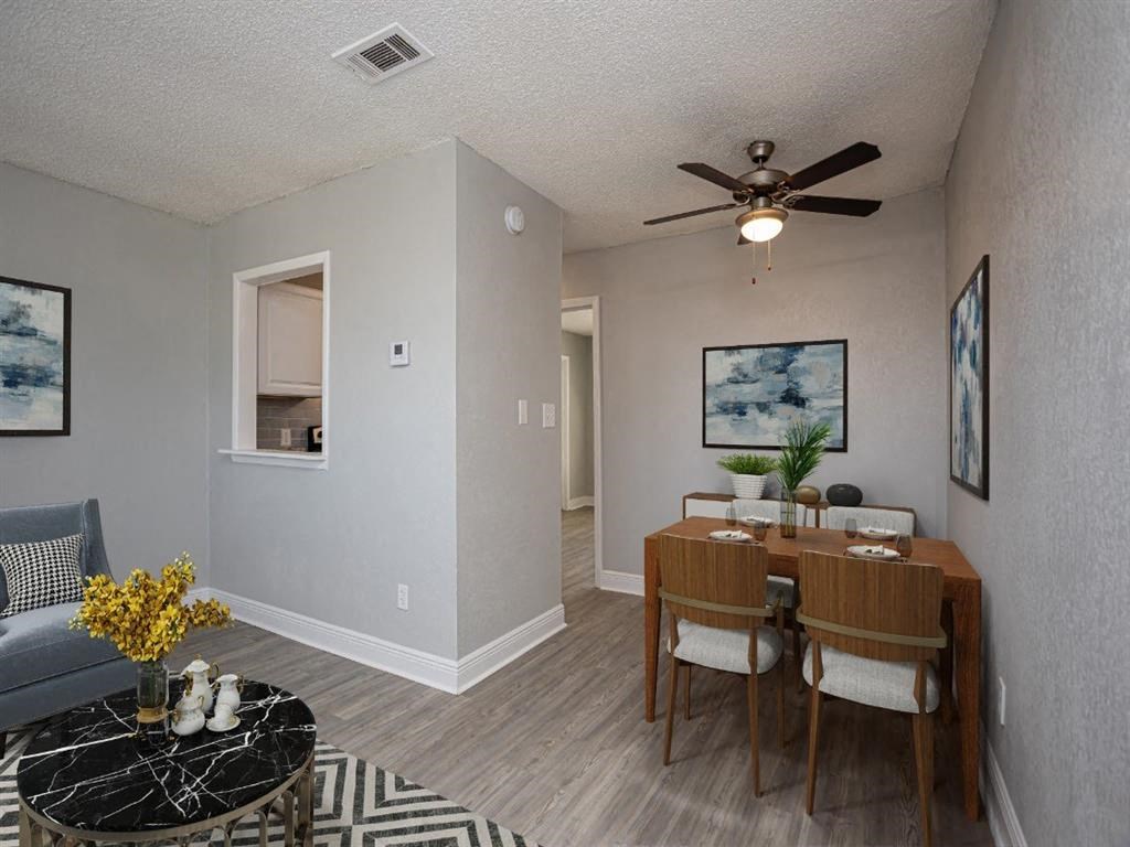 a dining room with a table and a ceiling fan