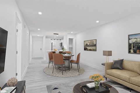 a living room with a couch and a table with chairs