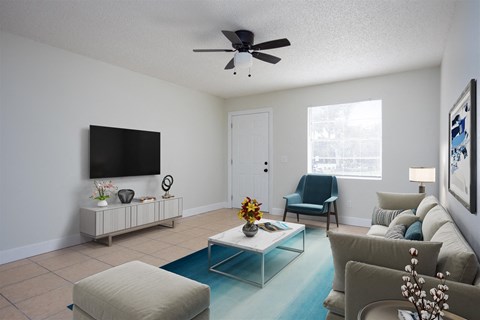 a living room with a couch and a ceiling fan