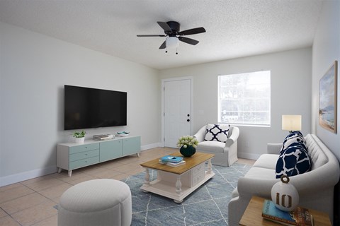 a living room with a ceiling fan and a tv