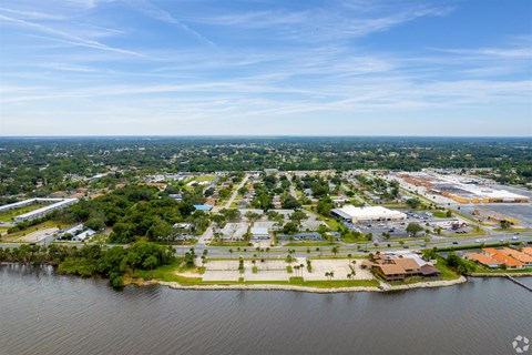 an aerial view of a city with a body of water