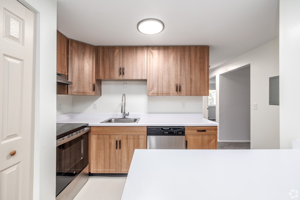 A kitchen with wooden cabinets and stainless steel appliances.