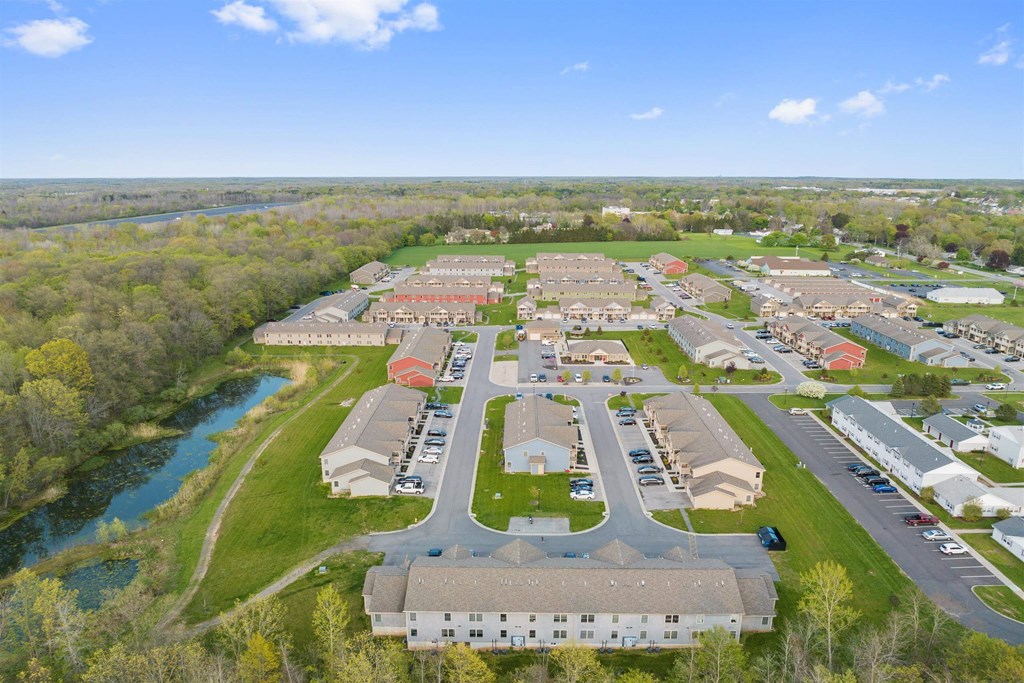 an aerial view of a community of buildings and a river