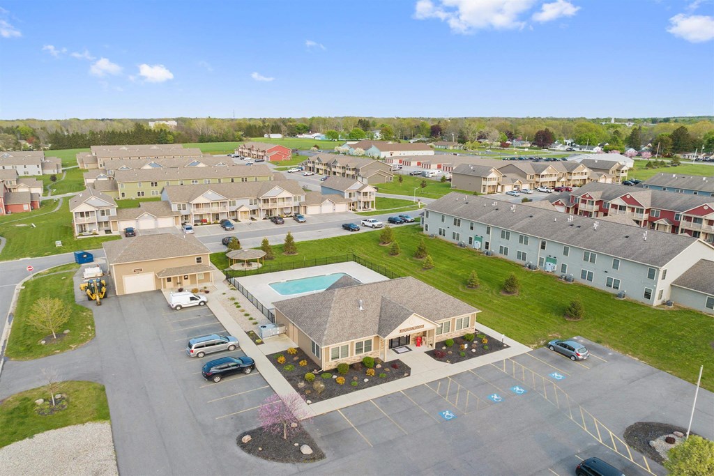 an aerial view of a community with houses and a swimming pool