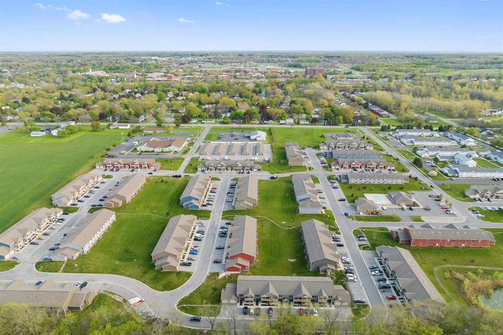 an aerial view of a neighborhood with cars parked in a parking lot