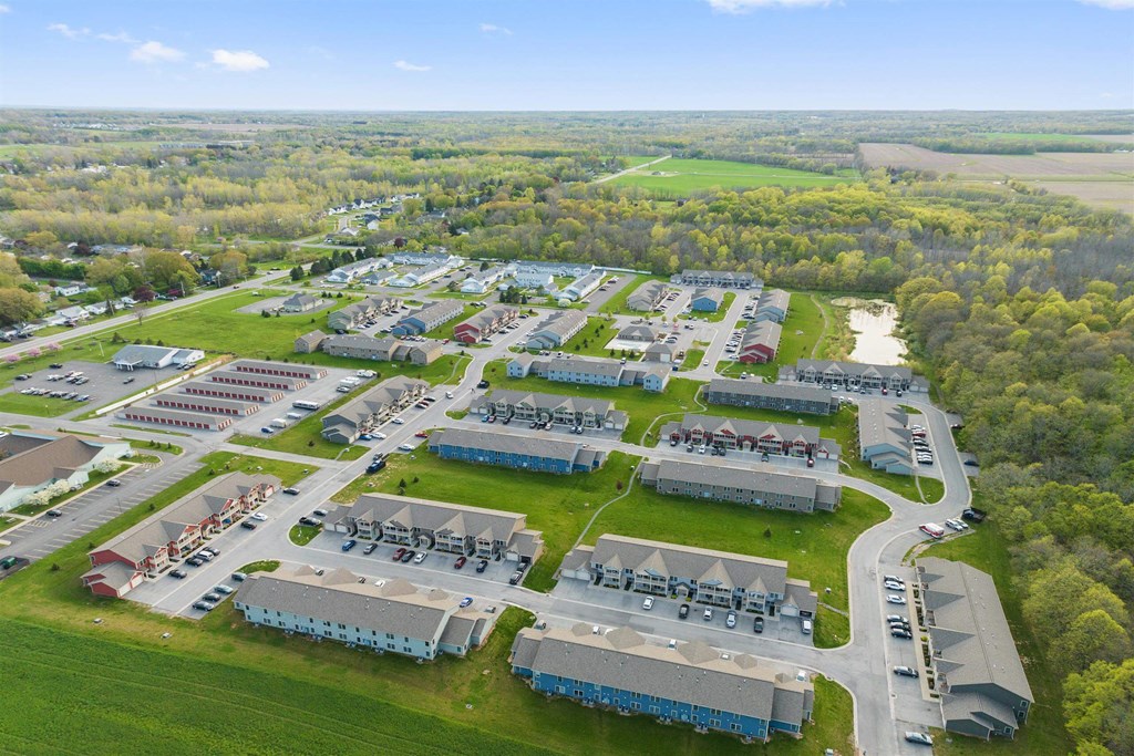 an aerial view of a community of buildings and green grass