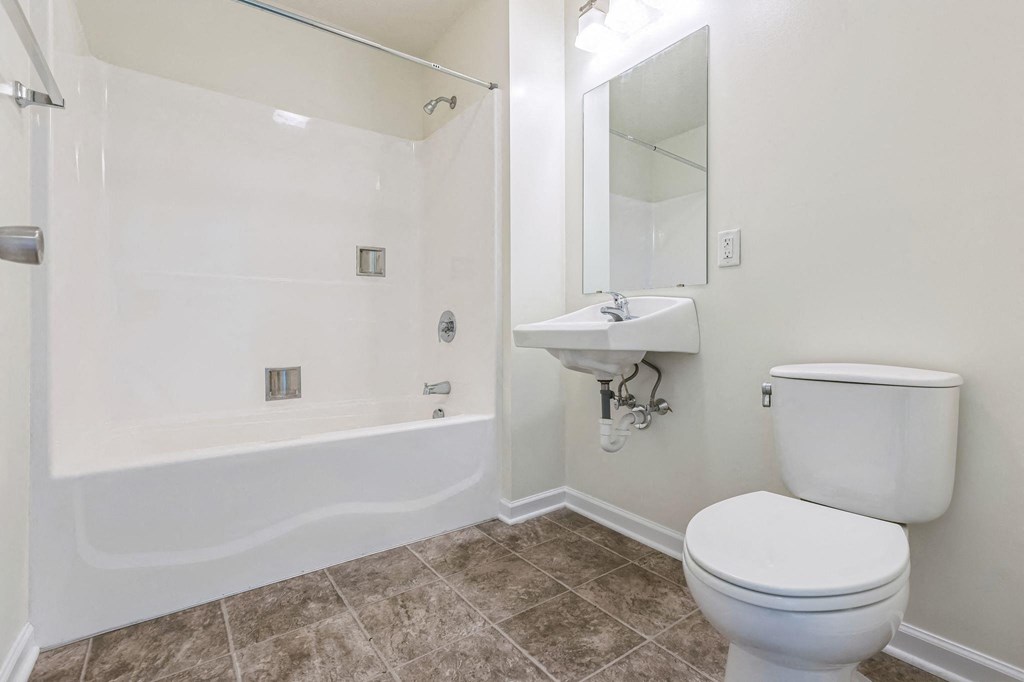 a bathroom with a toilet and a sink and a shower