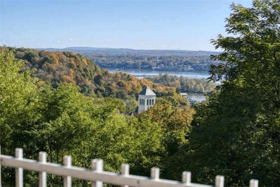 a view of a river and a building in the trees