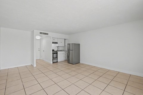 A kitchen area with a refrigerator, oven, and sink.