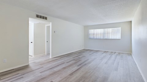 A room with a white door and a window with blinds.