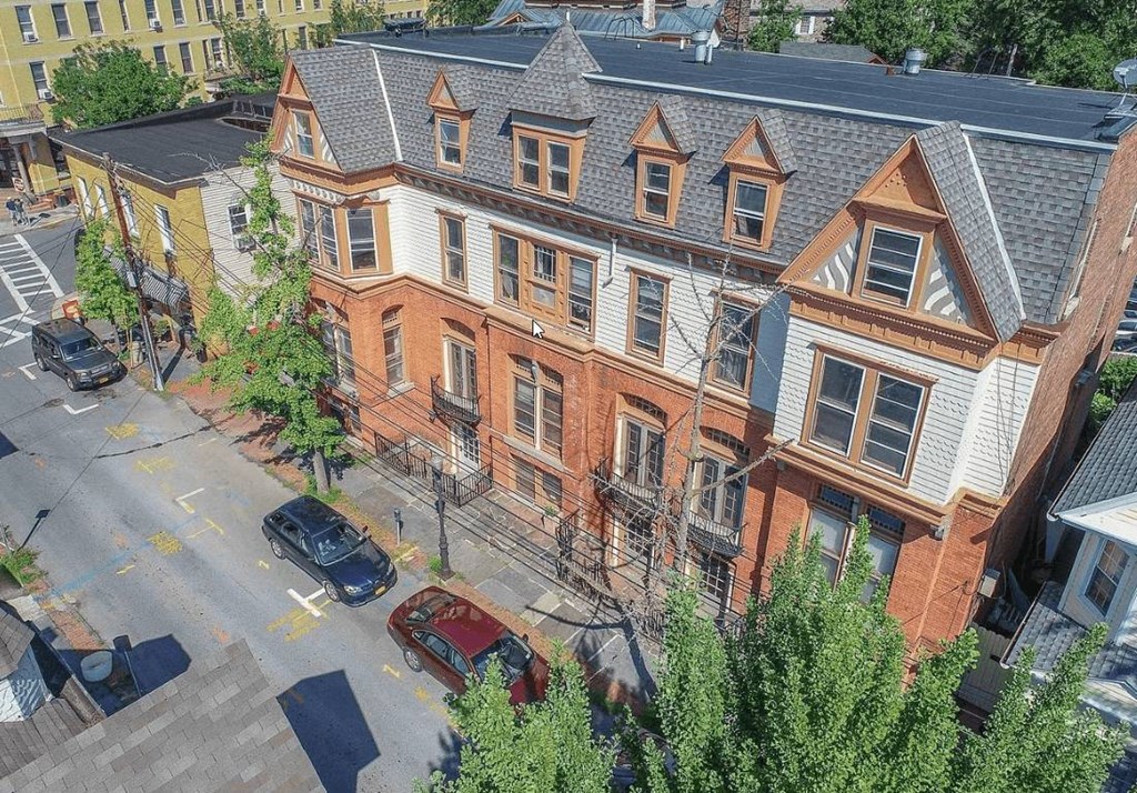 an aerial view of an apartment building on a city street