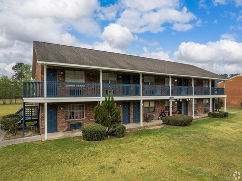 a house with a porch and a grass yard