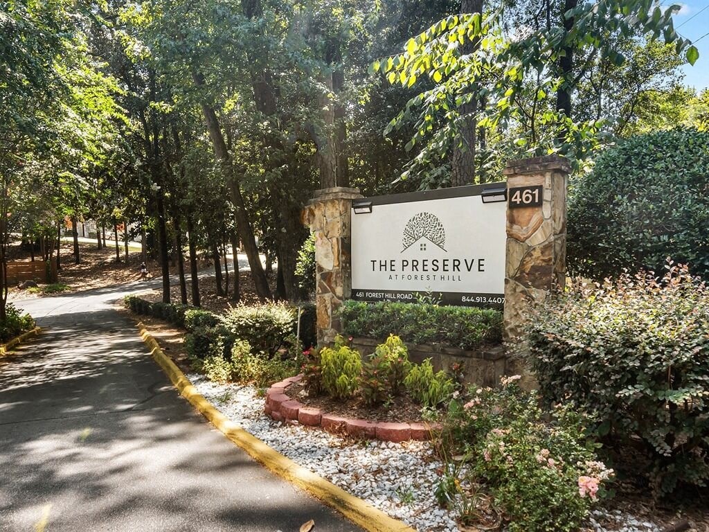 a sign for the preserve at the entrance of a park