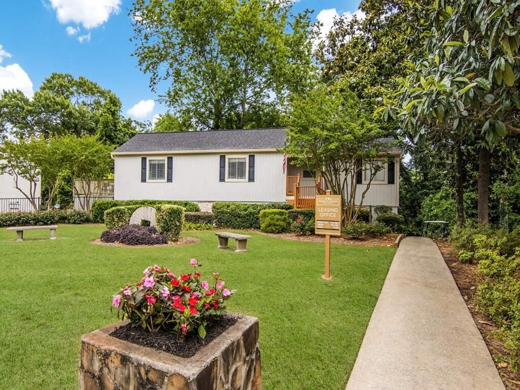 a house with a yard and a sign in front of it