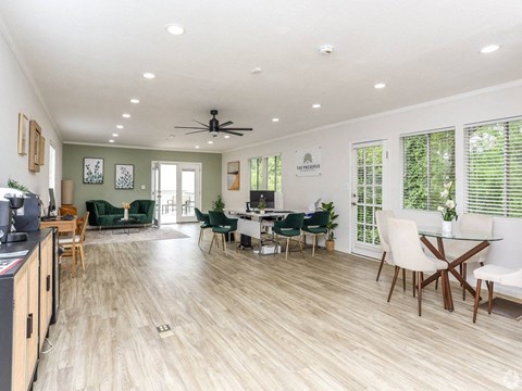 a living room and dining room with a table and chairs