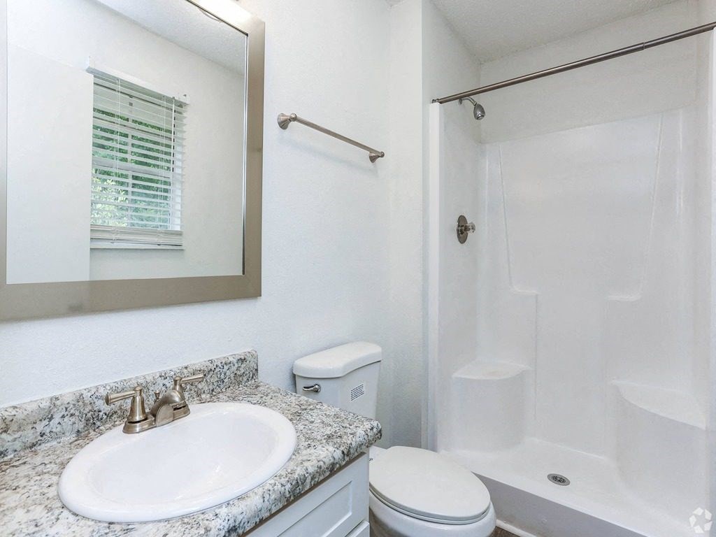 a bathroom with a sink toilet and a shower