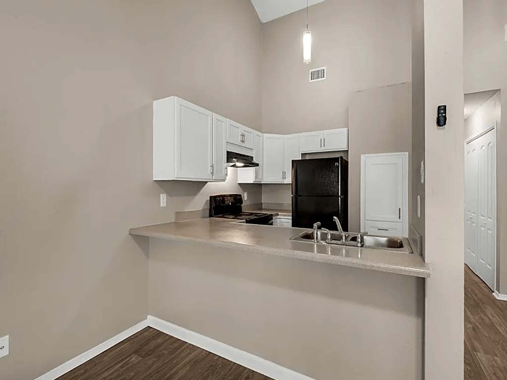 a kitchen with white cabinets and a counter top