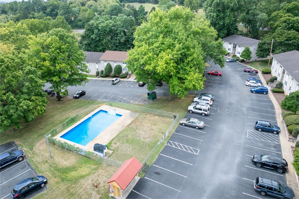 an aerial view of a swimming pool in a parking lot