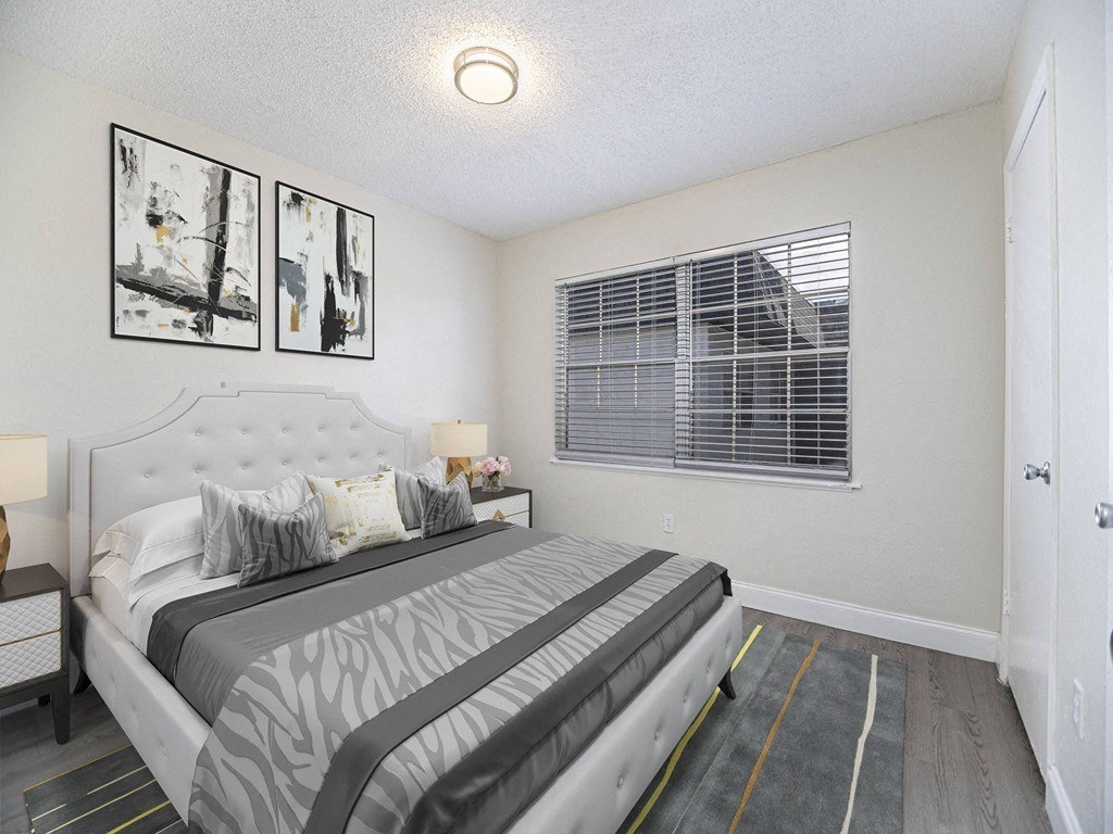 a white bedroom with a large bed and windows