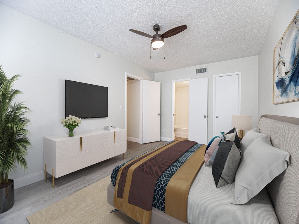 a bedroom with a bed and a ceiling fan