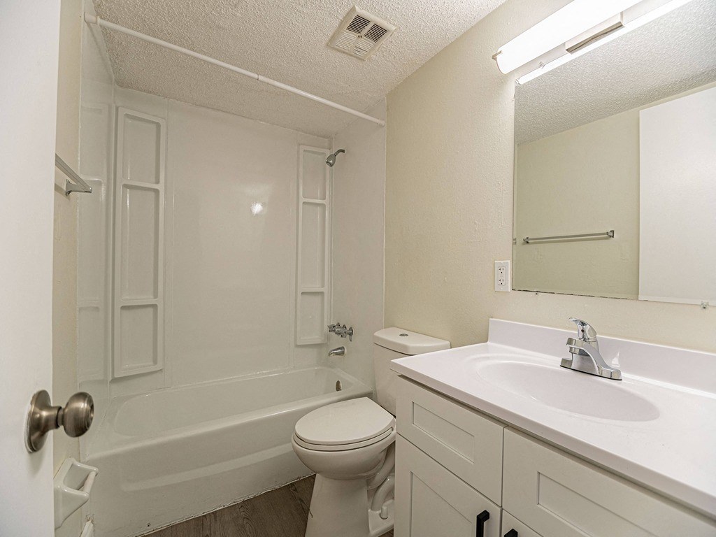 a bathroom with a sink toilet and a bath tub