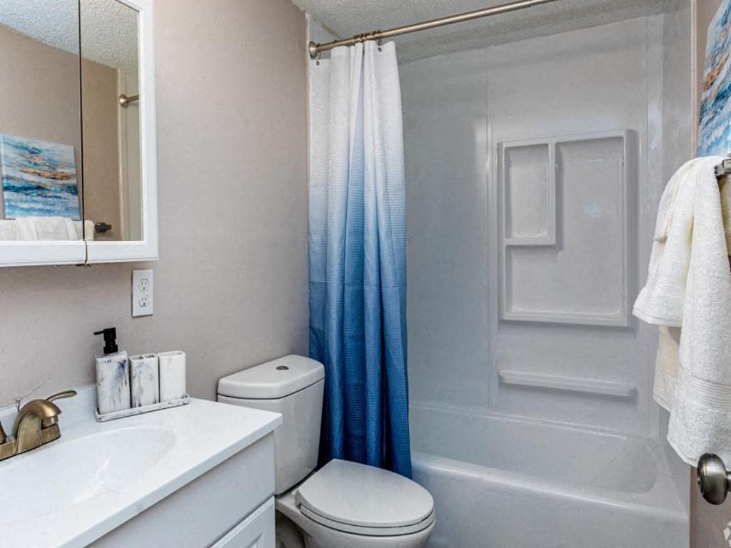 a bathroom with a sink toilet and a shower