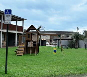 a playground in a yard in front of a house