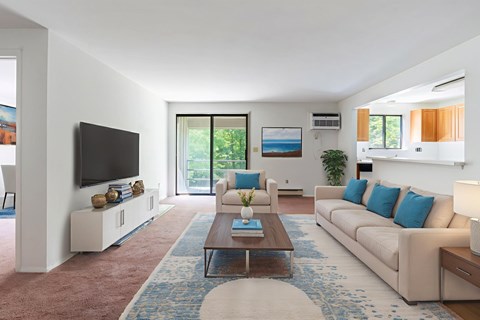 A living room with a white couch and a coffee table.