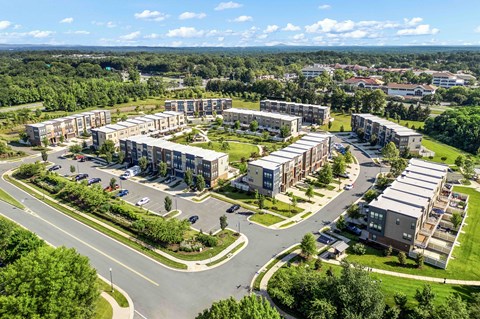 A bird's eye view of a residential area with multiple buildings and roads.