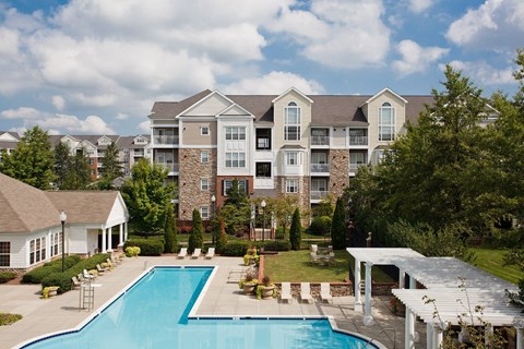 A large building with a pool in front.