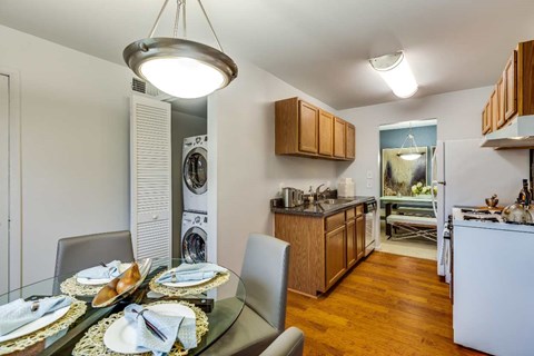 A modern kitchen with a dining table set for two.