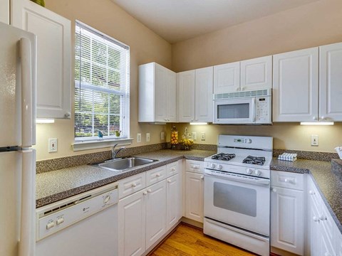 a kitchen with white appliances and white cabinets