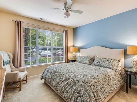 a bedroom with a bed and a ceiling fan