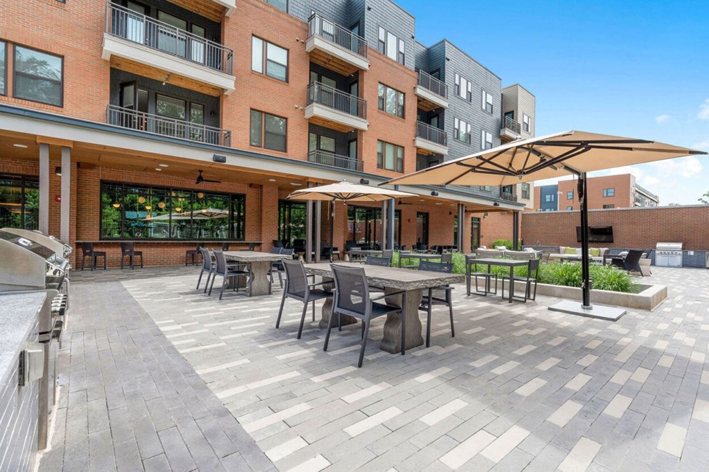a large patio with tables and chairs and umbrellas