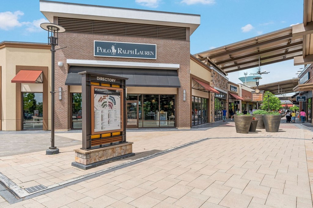 a shopping center with a sign in front of a building
