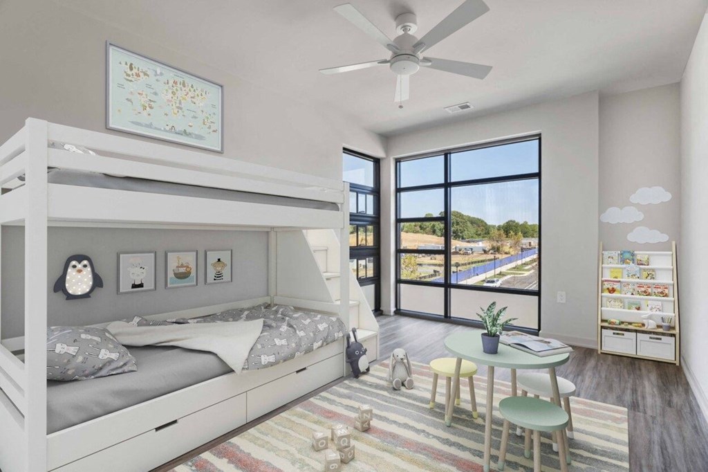 a bedroom with a bunk bed and a large window