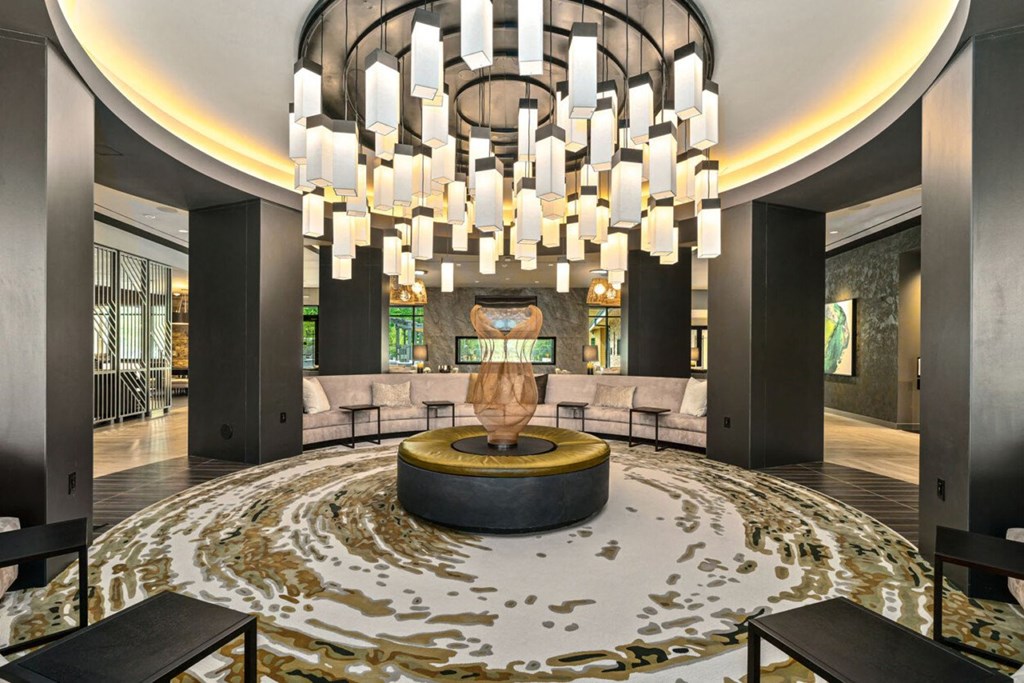 a large lobby with a large chandelier and a seating area