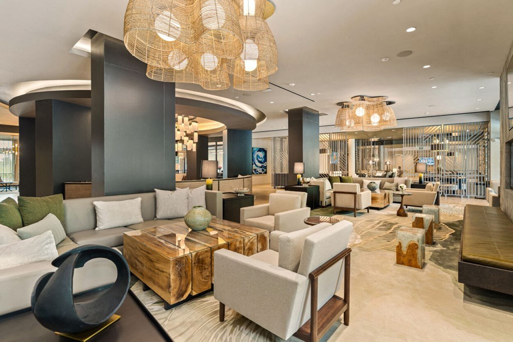 the lobby of a hotel with couches and chairs