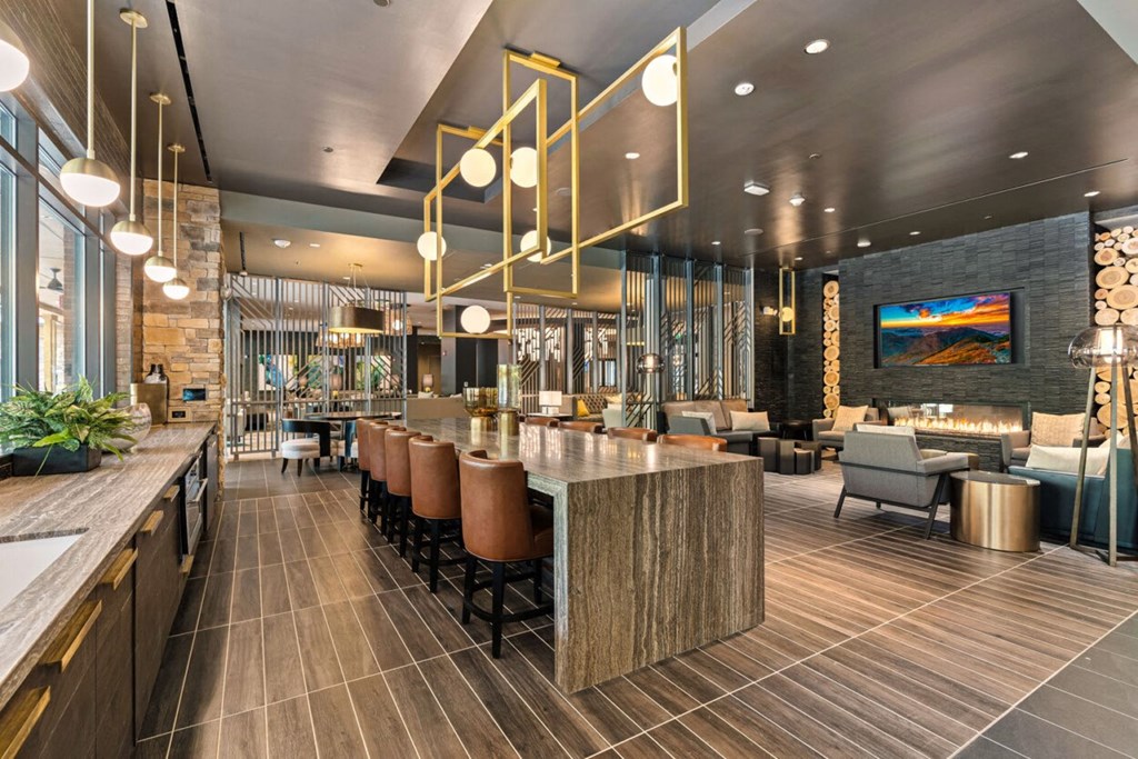 a restaurant with a long bar and chairs in a lobby