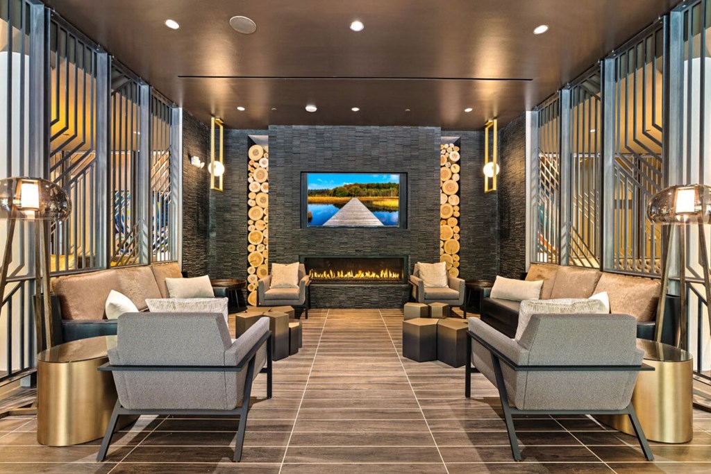 a lobby with couches and chairs and a fireplace