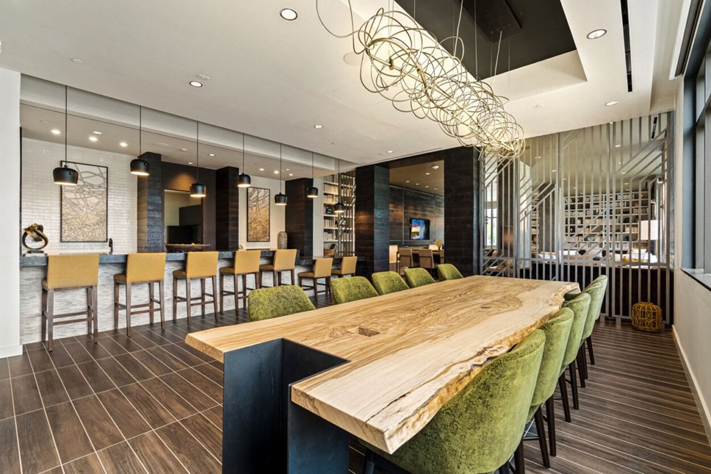 a dining room with a wooden table and chairs