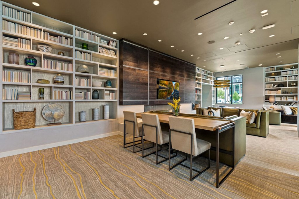 a dining room with a table and chairs and a library