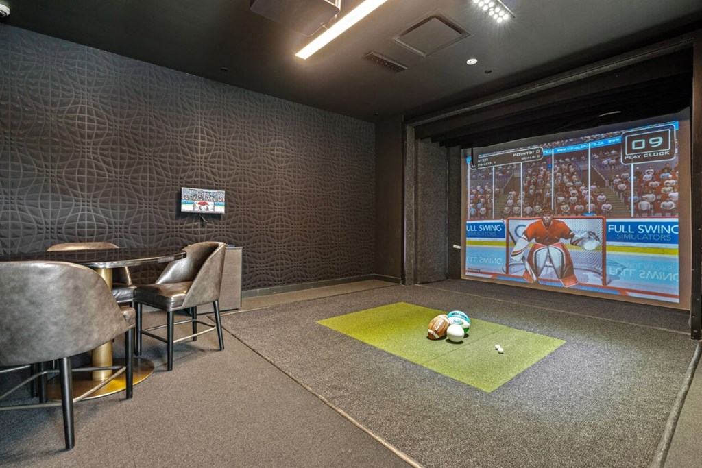 a room with a projector screen and a ball on the floor