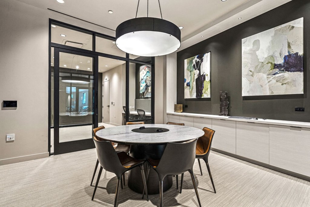a dining room with a marble table and chairs