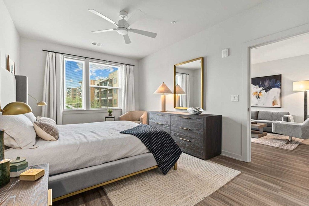a bedroom with a bed and a ceiling fan