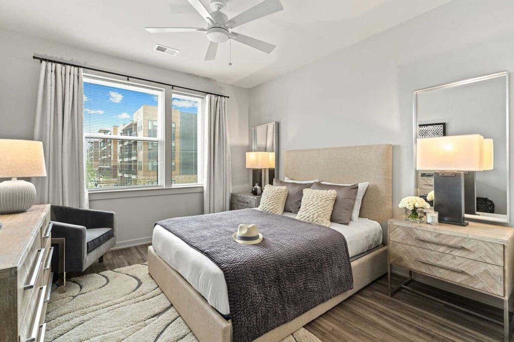 a bedroom with a bed and a ceiling fan