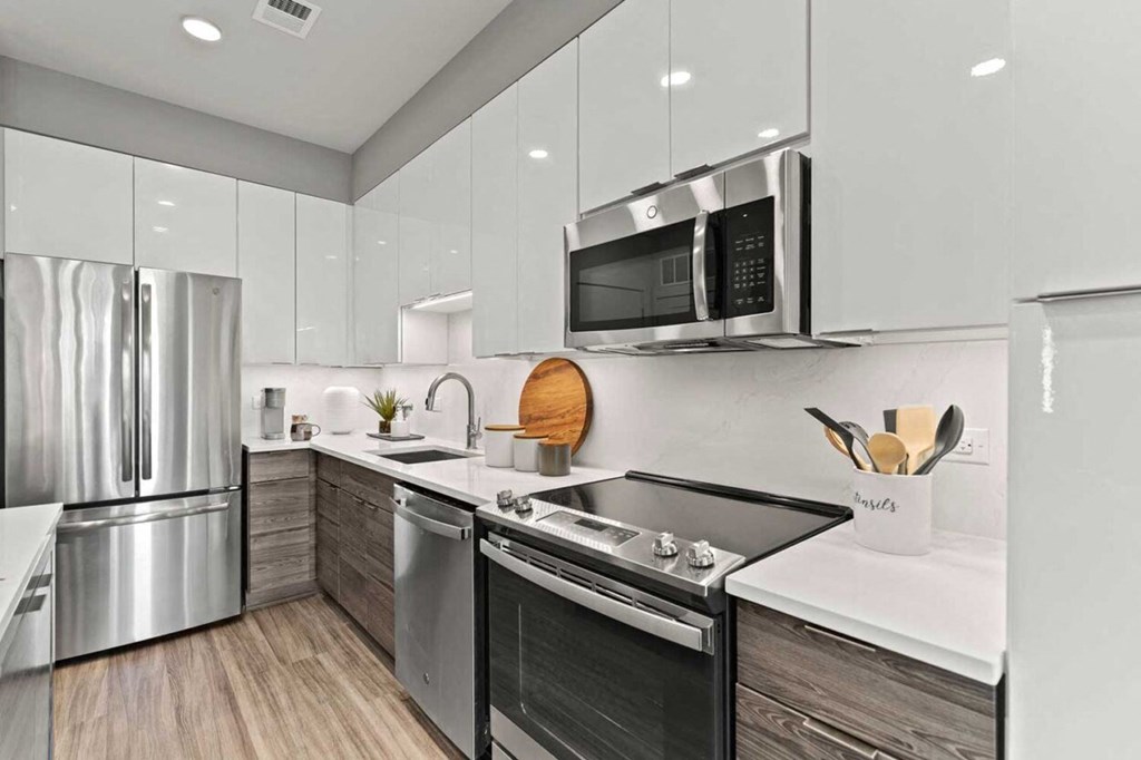 a kitchen with stainless steel appliances and a microwave