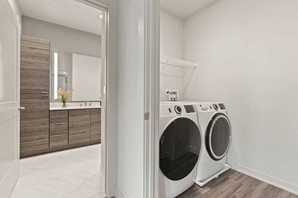 a washer and dryer in a laundry room next to a bathroom